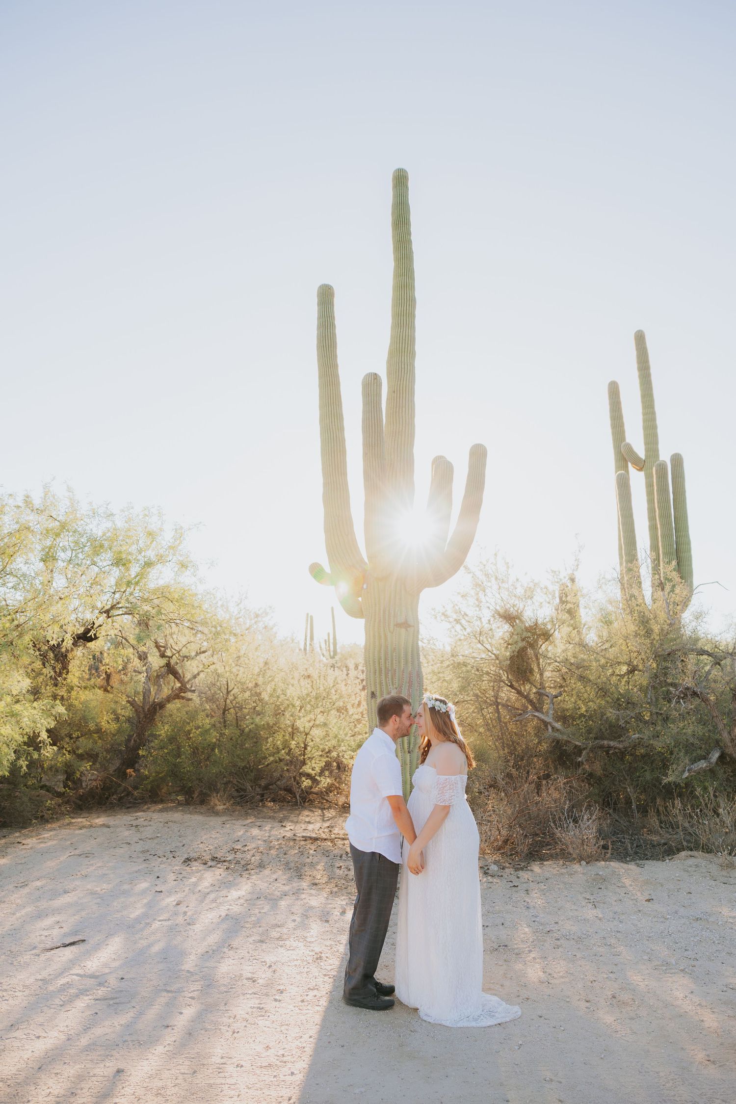 Desert wedding photography with saguaro cacti silhouettes at golden hour.