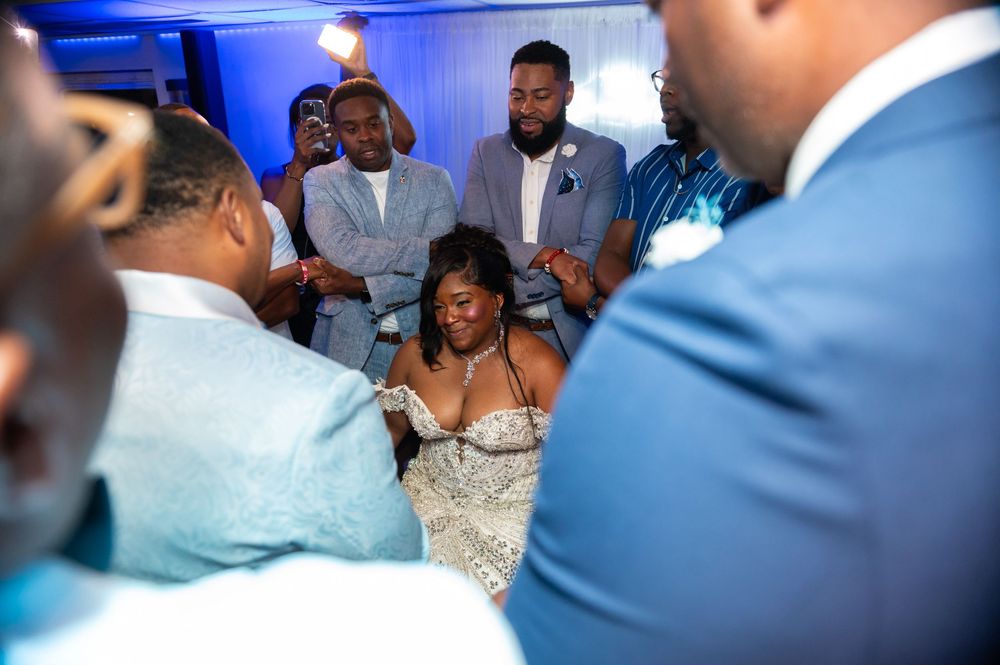 Couples and guests raising glasses during yacht wedding toast