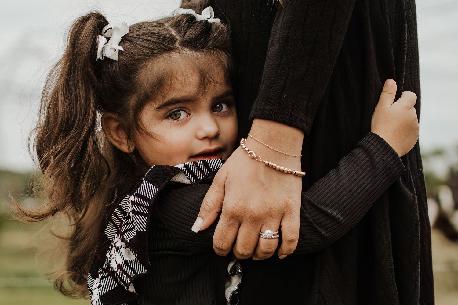 Intimate family portrait details with jewelry and holding hands. Crowley Family Photographer