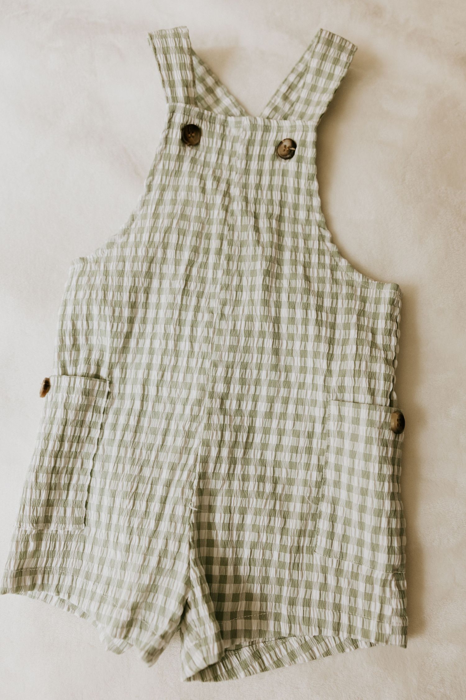 Adorable vintage-inspired baby boy outfit with white button-down shirt, blue striped suspender shorts and matching bowtie.
