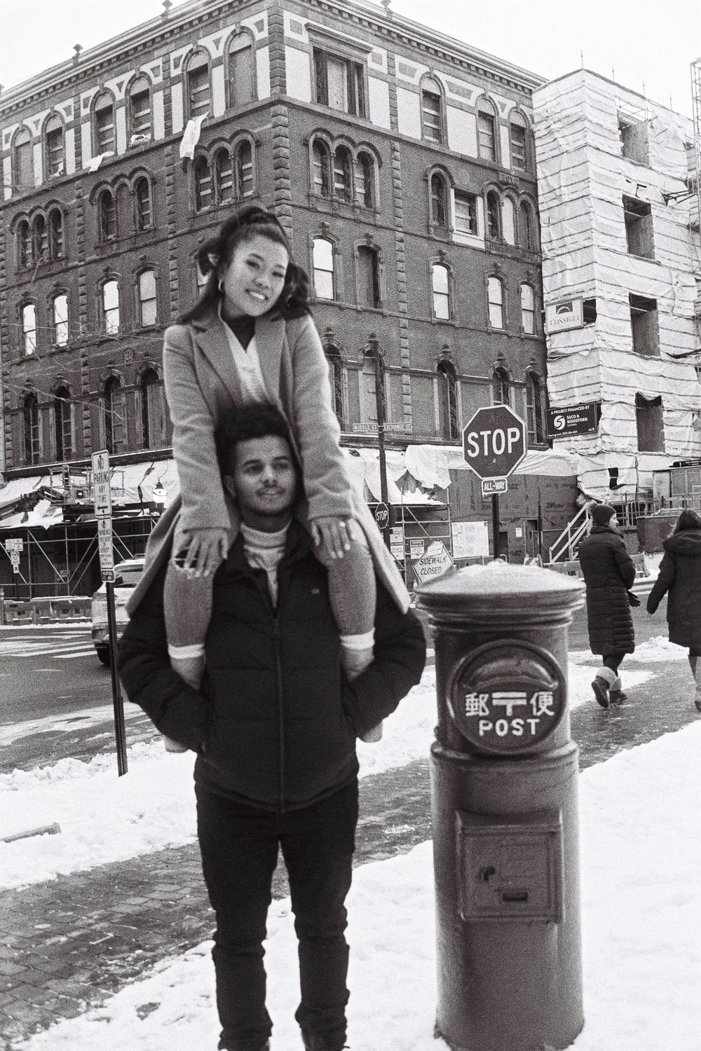 A recently engaged couple poses in a park on a winters day in downtown Portland, Maine on black and white 35mm film.