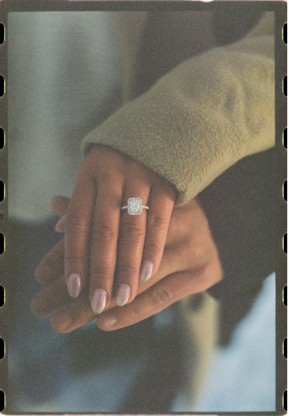 Detail photo of the engagement ring of a recently engaged couple on a winter's day in South Portland, Maine.