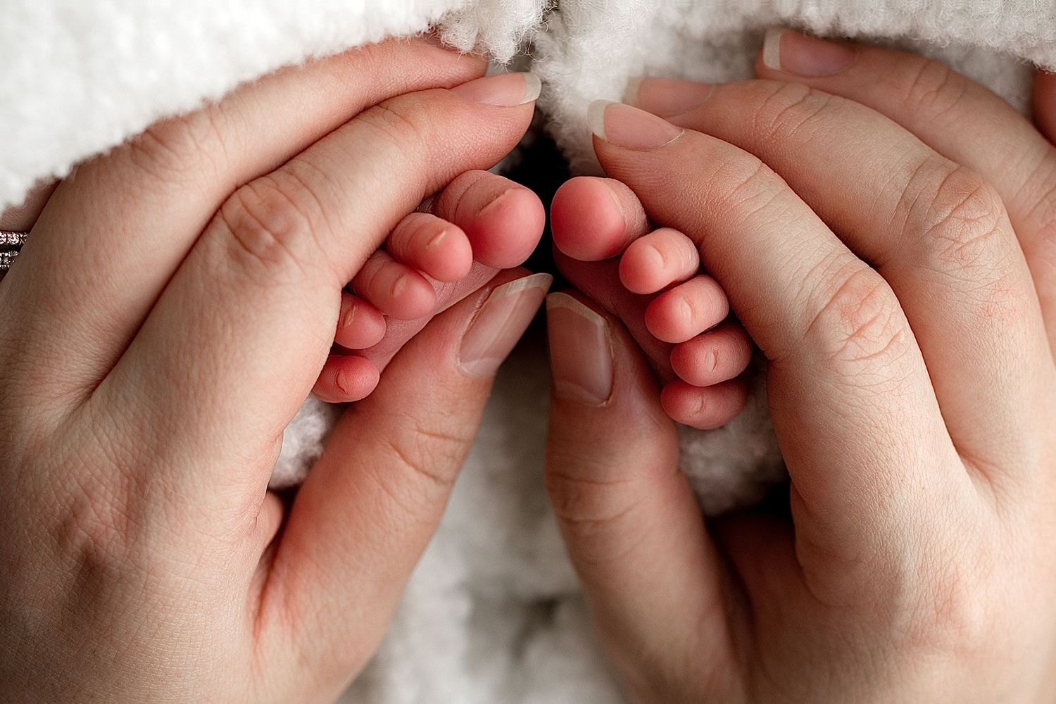 Best newborn photographer Mater Mothers Brisbane – Springfield Lakes studio portraits. a Mother’s touch, gently holding baby’s feet, natural
