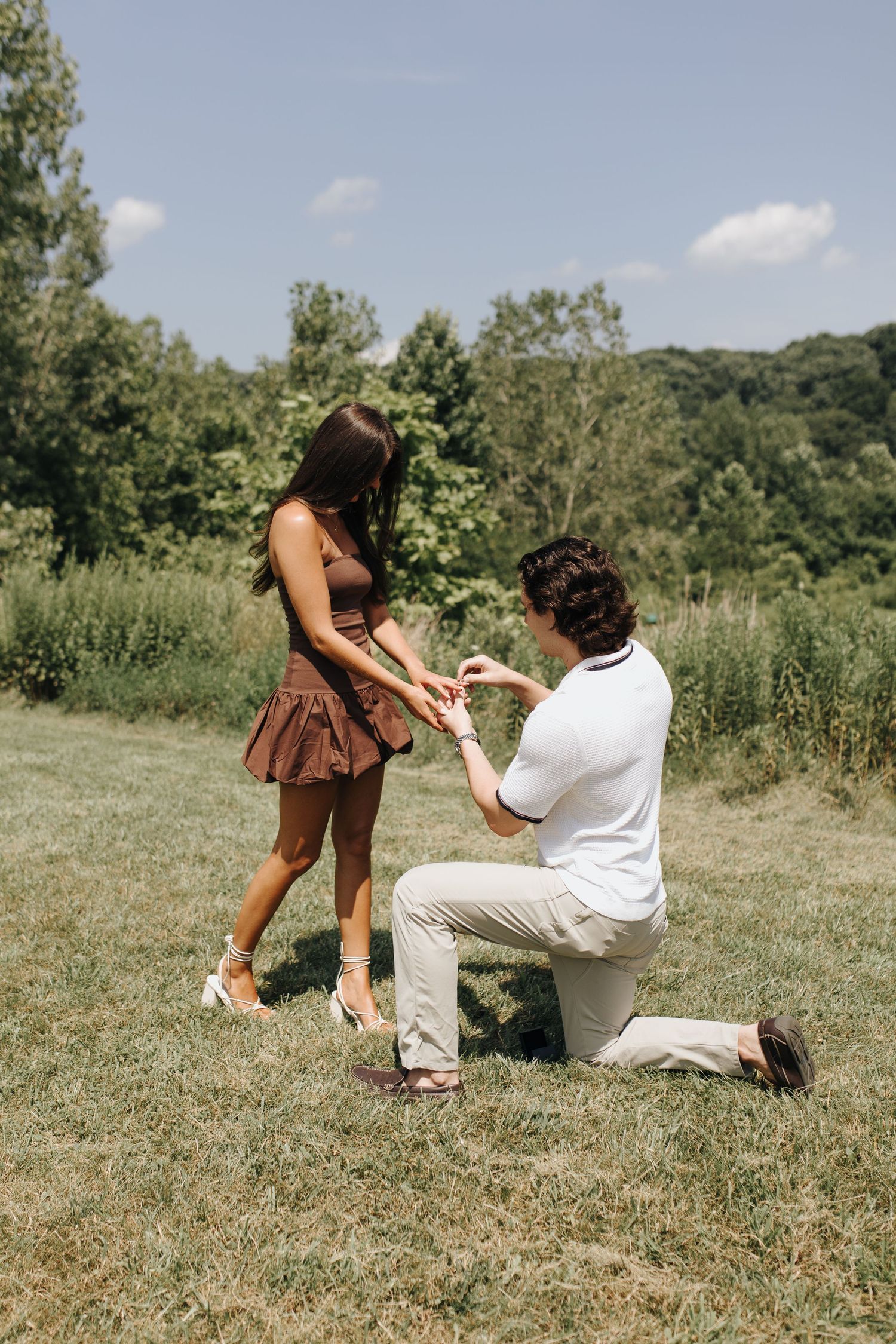 Martin on one knee proposing to Brooke at the River Bluff overlook at High Banks Metro Park in Columbus, Ohio.