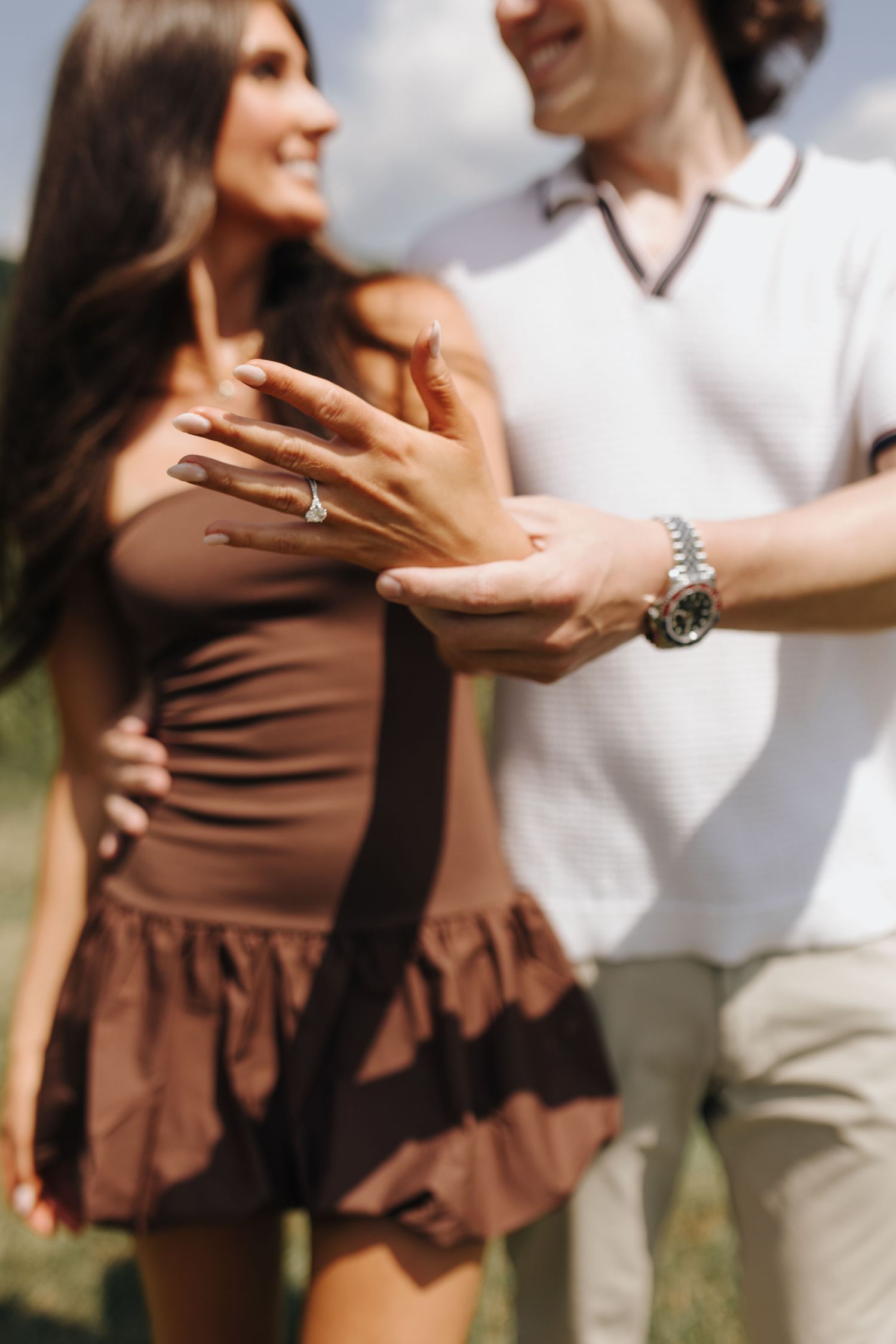 Ring detail on Brooke's hand while Martin is holding it out.