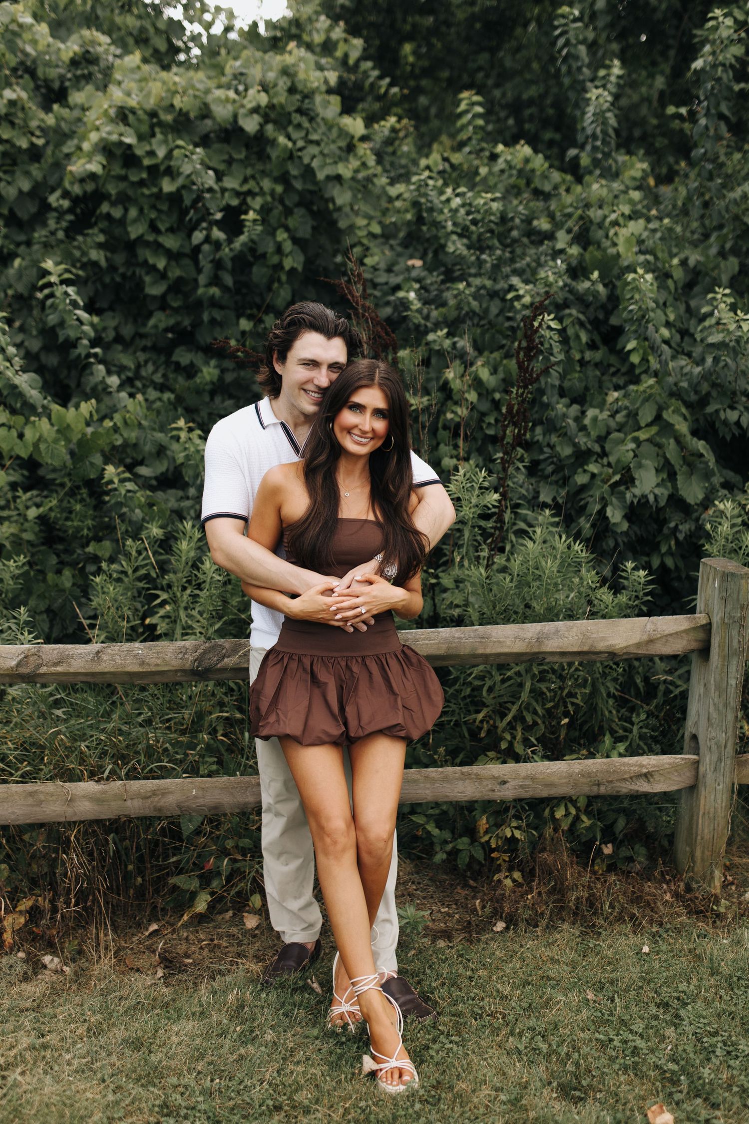 Romantic engagement portrait of couple embracing happily after the big "YES!"