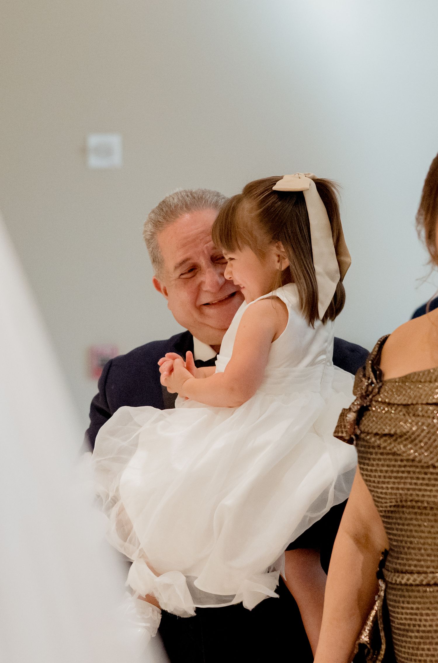 A joyful moment captured as family members share warm embraces and laughter during a gathering.