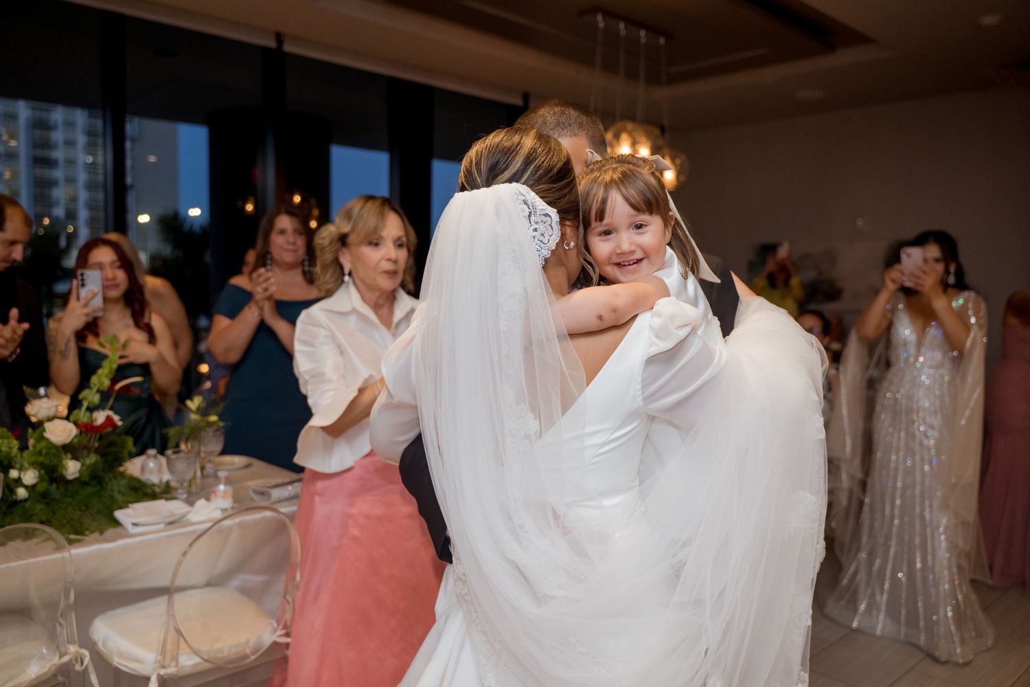 Joyful wedding reception scenes with dancing and entertainment in an indoor venue.