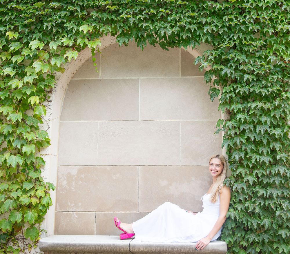 A wall covered in lush green ivy vines creates a natural backdrop for special event or wedding photography.