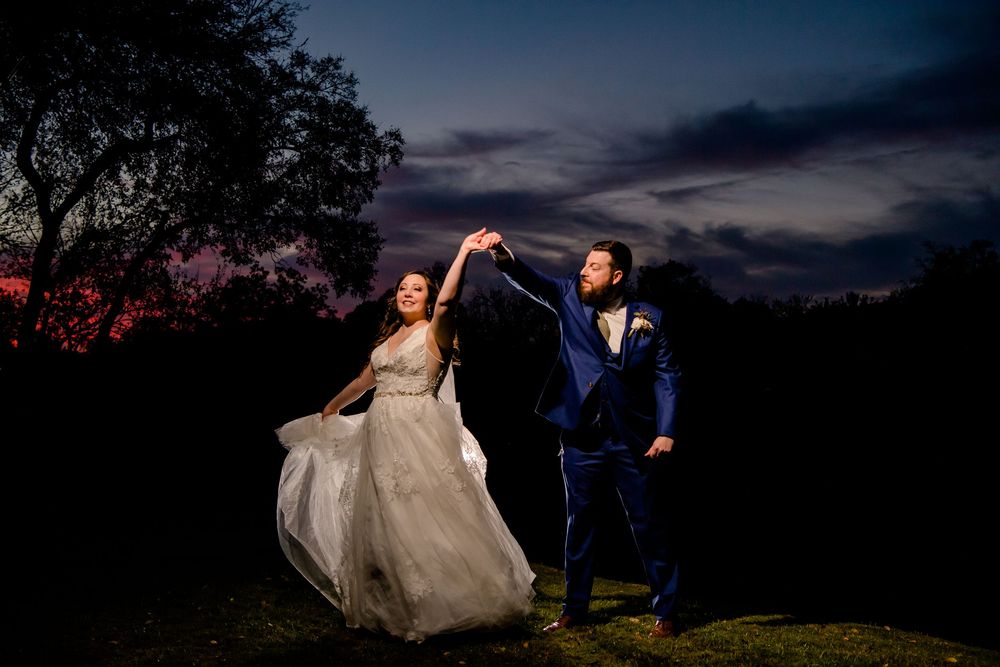 Two people share intimate dance poses during sunset at a romantic outdoor wedding photoshoot.