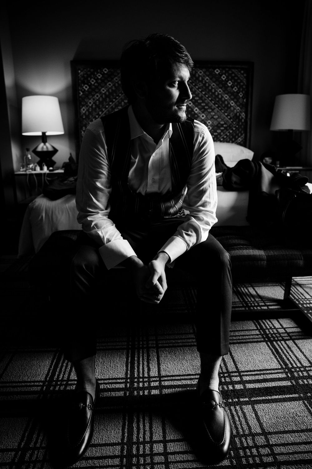 Dramatic black and white photo sequence of a seated figure casting long shadows through window blinds on a carpet.