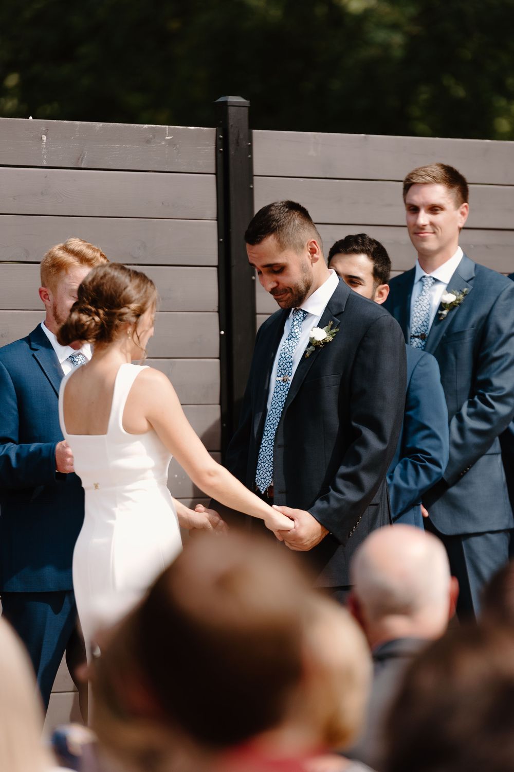 A sequence of wedding photos shows a bride in white dress dancing with groomsmen in navy suits at an outdoor reception.
