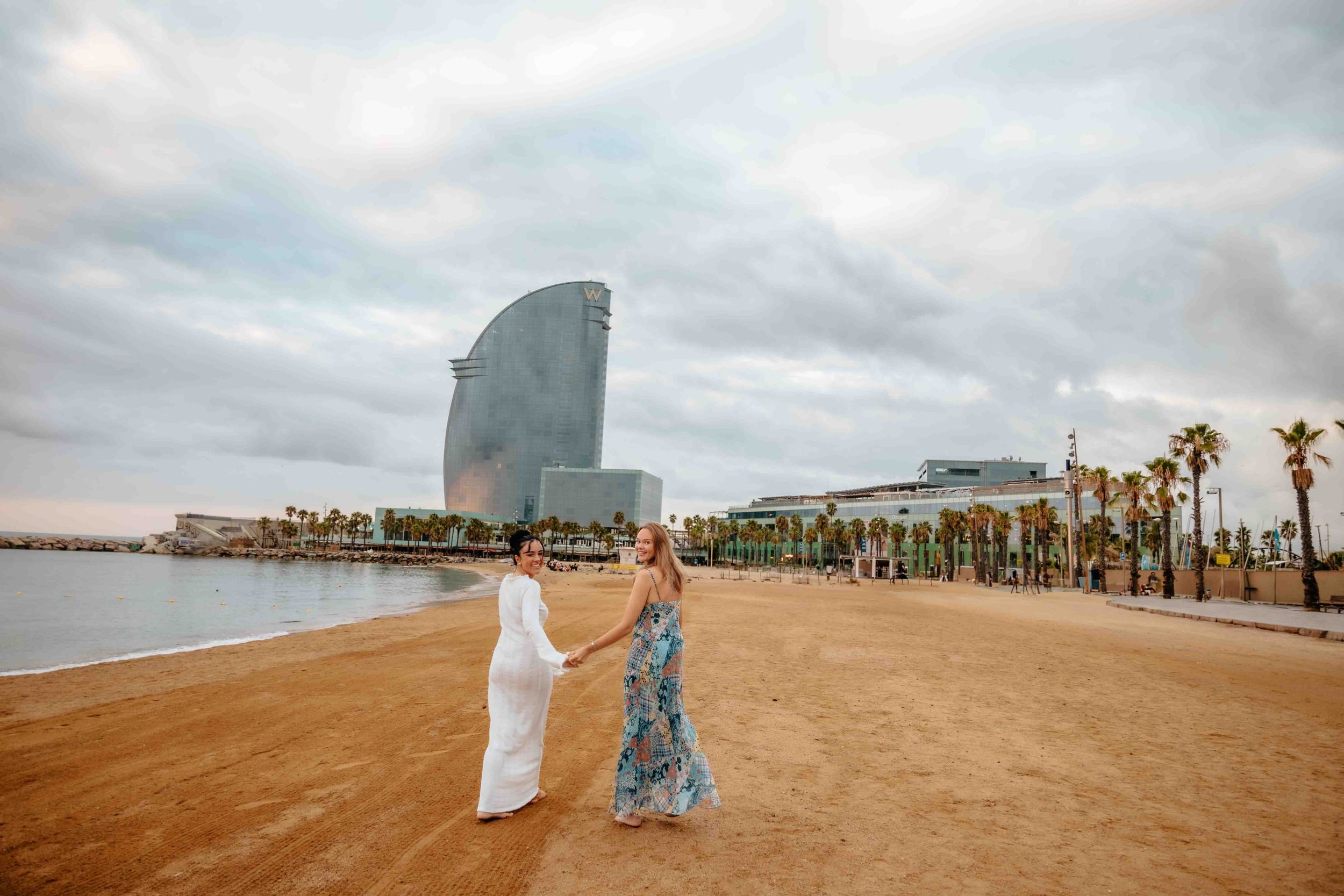 Elegant and natural couple portraits on Barceloneta Beach in the morning