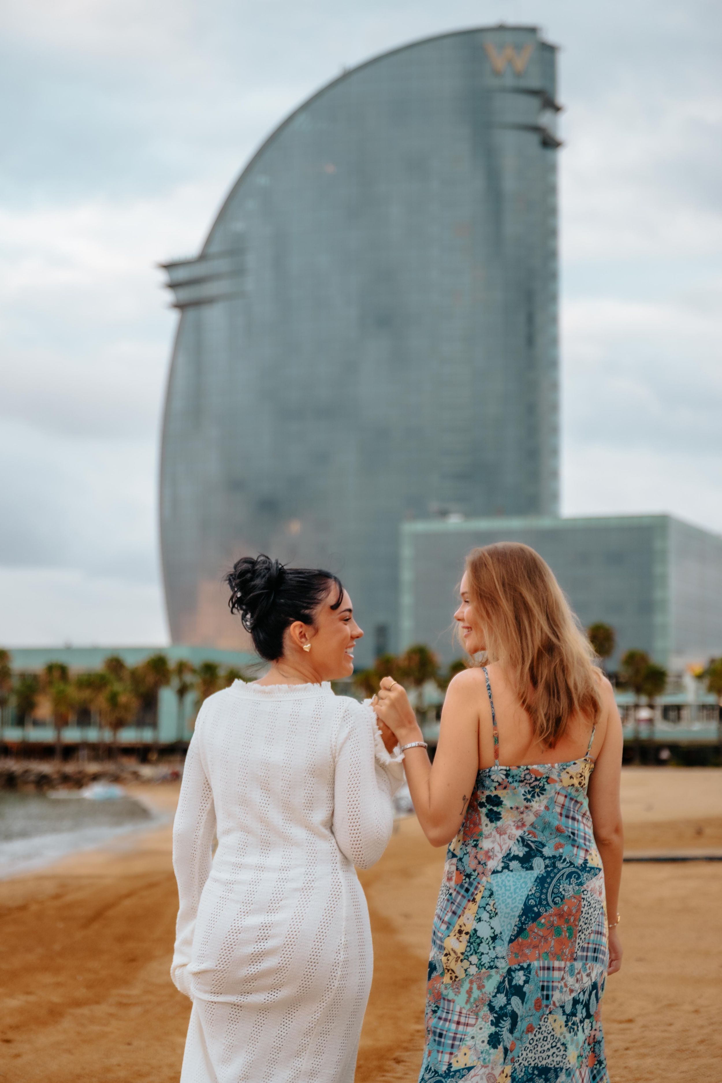 Elegant and natural couple portraits on Barceloneta Beach in the morning