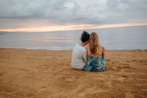 Elegant and natural couple portraits on Barceloneta Beach in the morning