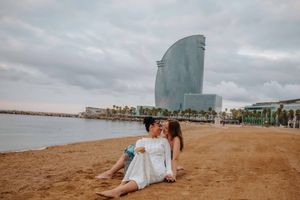Elegant and natural couple portraits on Barceloneta Beach in the morning