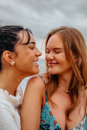 Couple laughing together during a morning photoshoot at Barceloneta Beach