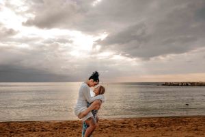 Couple holding hands on Barceloneta Beach in the morning