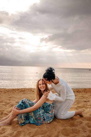 Loving couple walking along Barceloneta Beach in early morning light