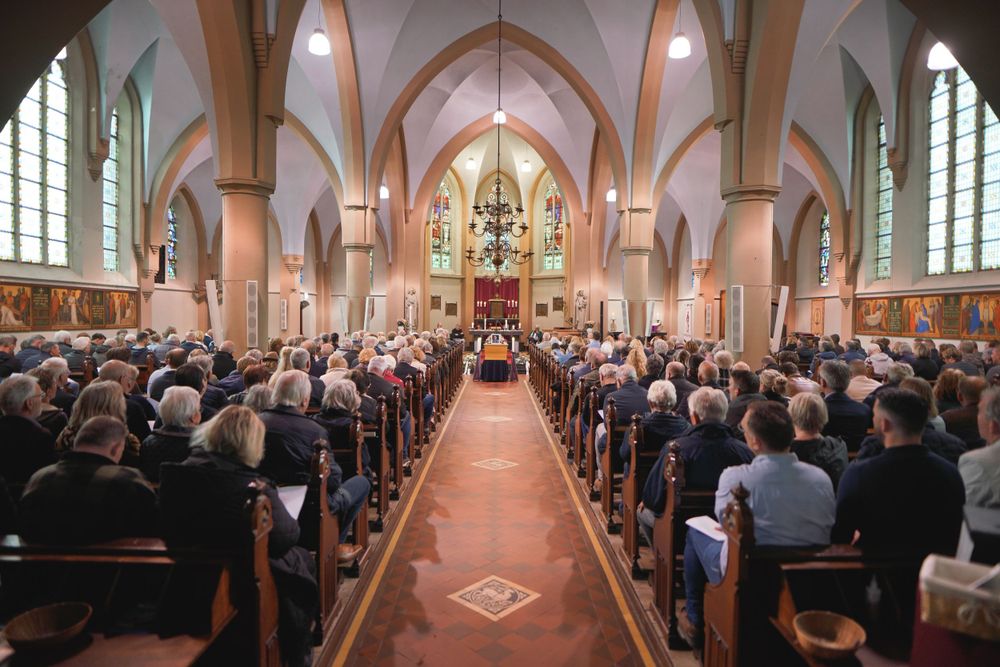 Large cathedral filled with people during a traditional church ceremony.