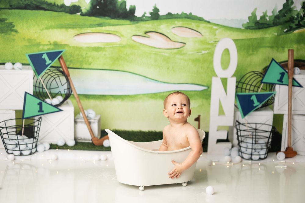 A series of golf course landscape paintings displayed alongside interior design elements and furniture pieces.