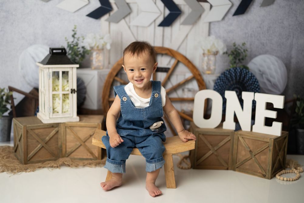 A collection of milestone photos showing a baby's growth and development through their first year.