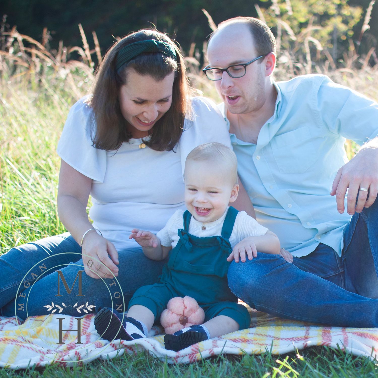 family sitting with toddler boy