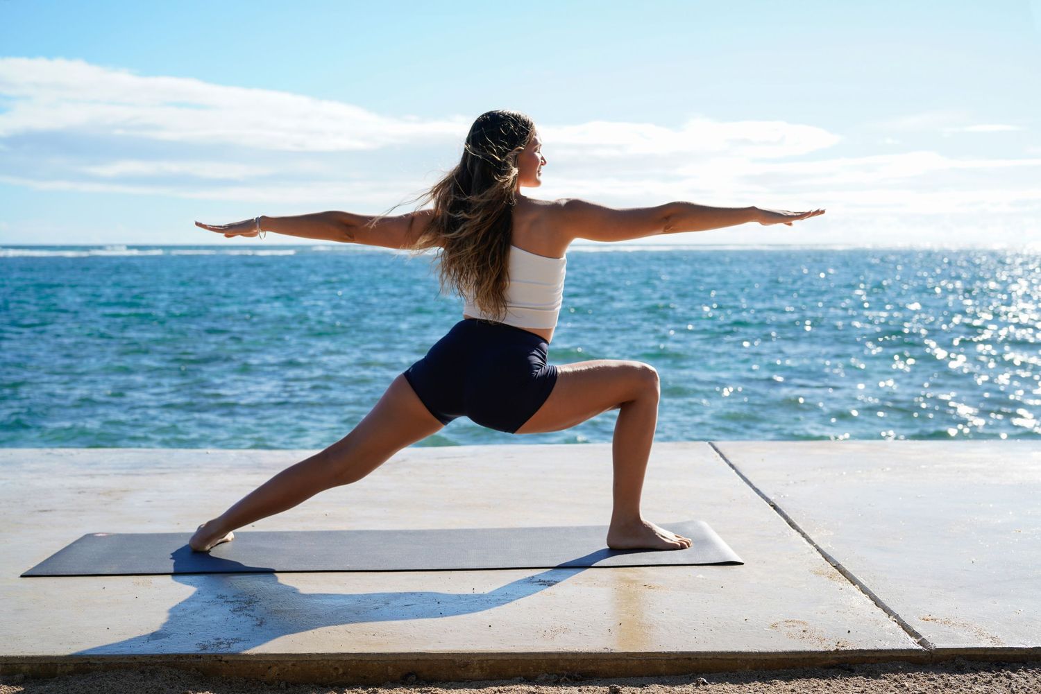 Yoga teacher in Ballerina pose at a hawaiian beach
