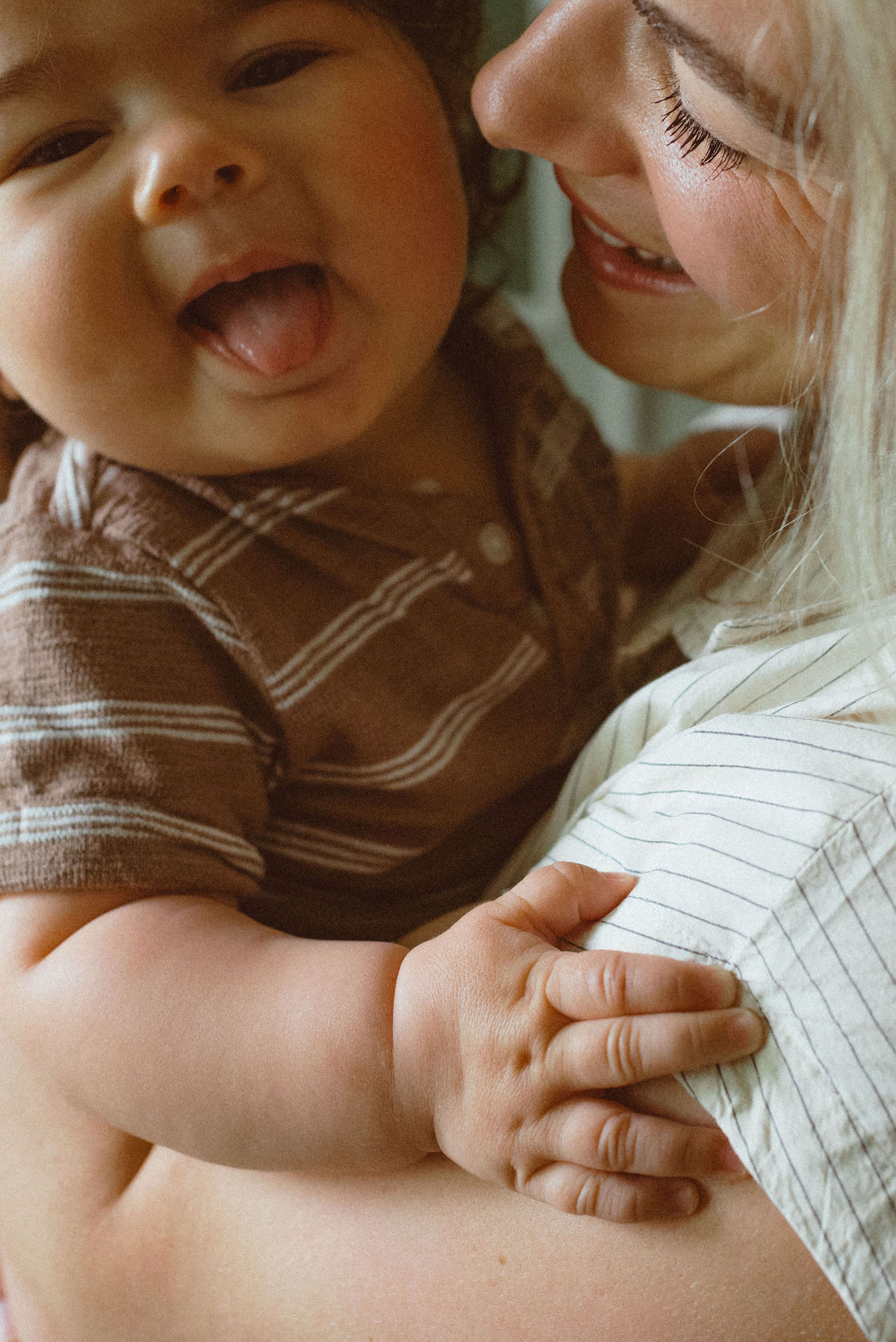 A sequence of intimate photos showing tender moments between a parent and baby in soft, natural lighting.