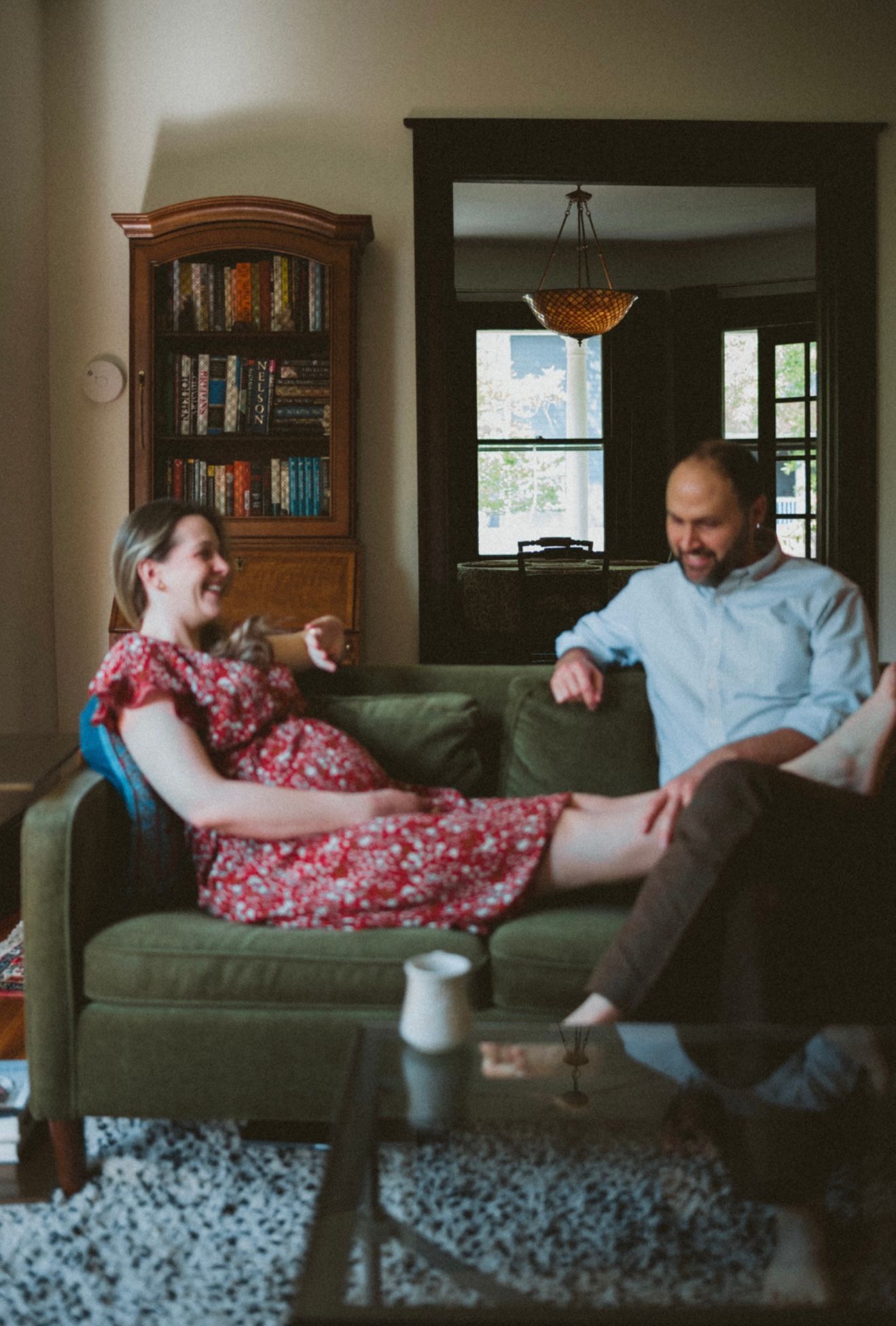 A sequence of images shows a playful moment on a couch, progressing from sitting to falling backwards with dynamic movement.