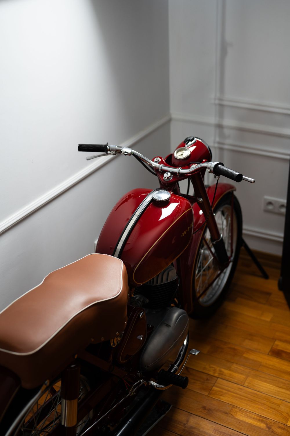 Premium motorcycle photography showcasing a red classic bike in a modern interior. Ideal for brands, product catalogs, and campaigns.
