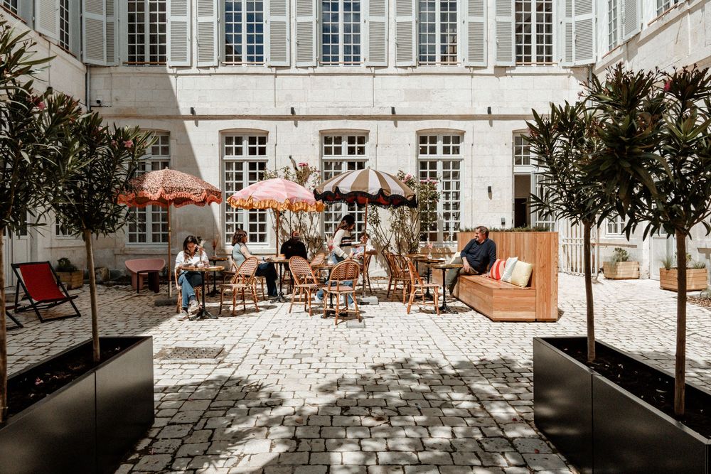 photo d'une terrasse avec des clients prenant le déjeuner et un café