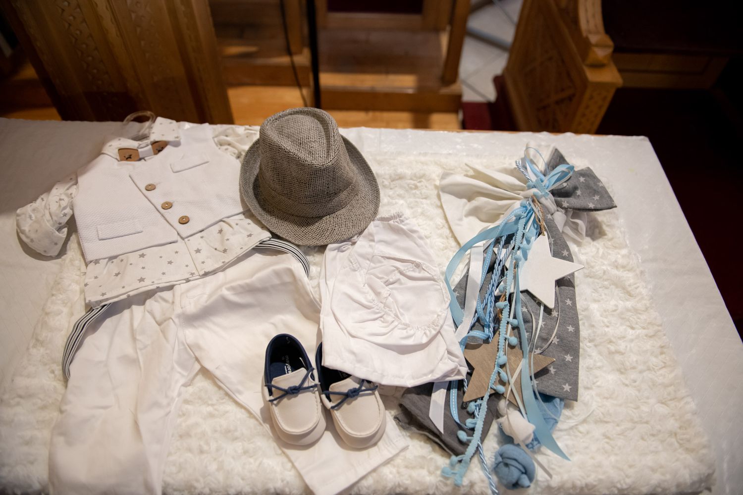 Baby boy baptism outfit with white suit, hat, shoes, and blue accessories.