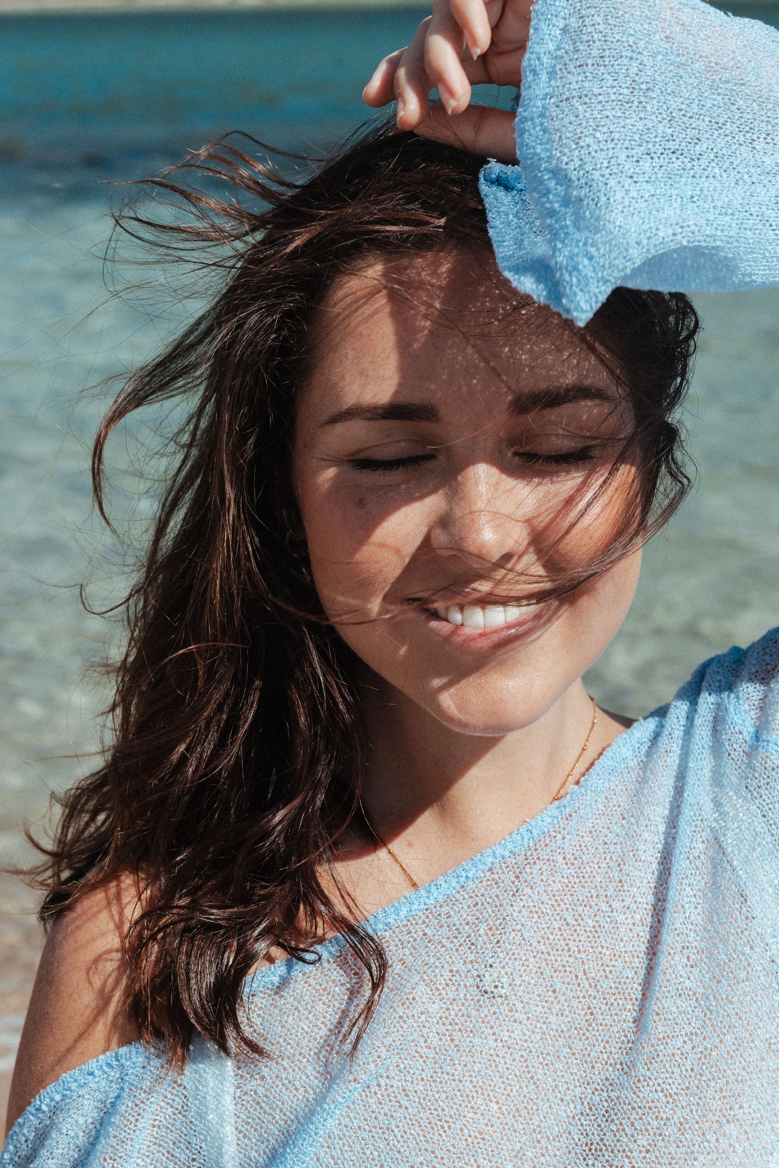 Professional smiling headshot portrait of a female photographer with natural light and soft background