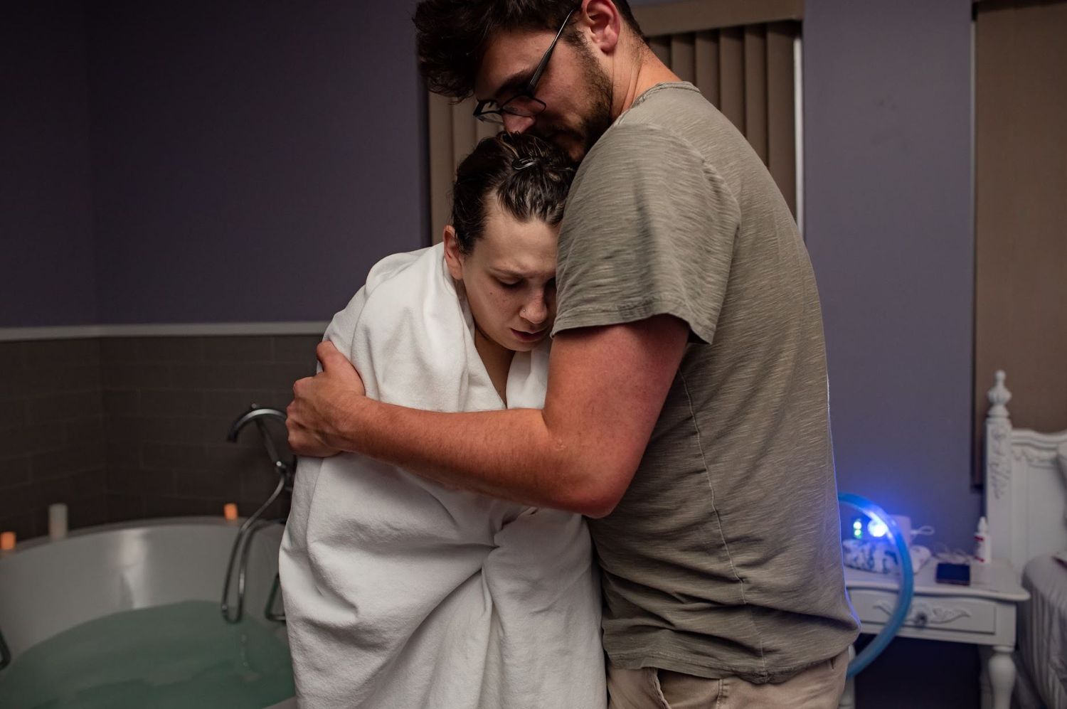 Mom and dad hugging during labor at a birth center