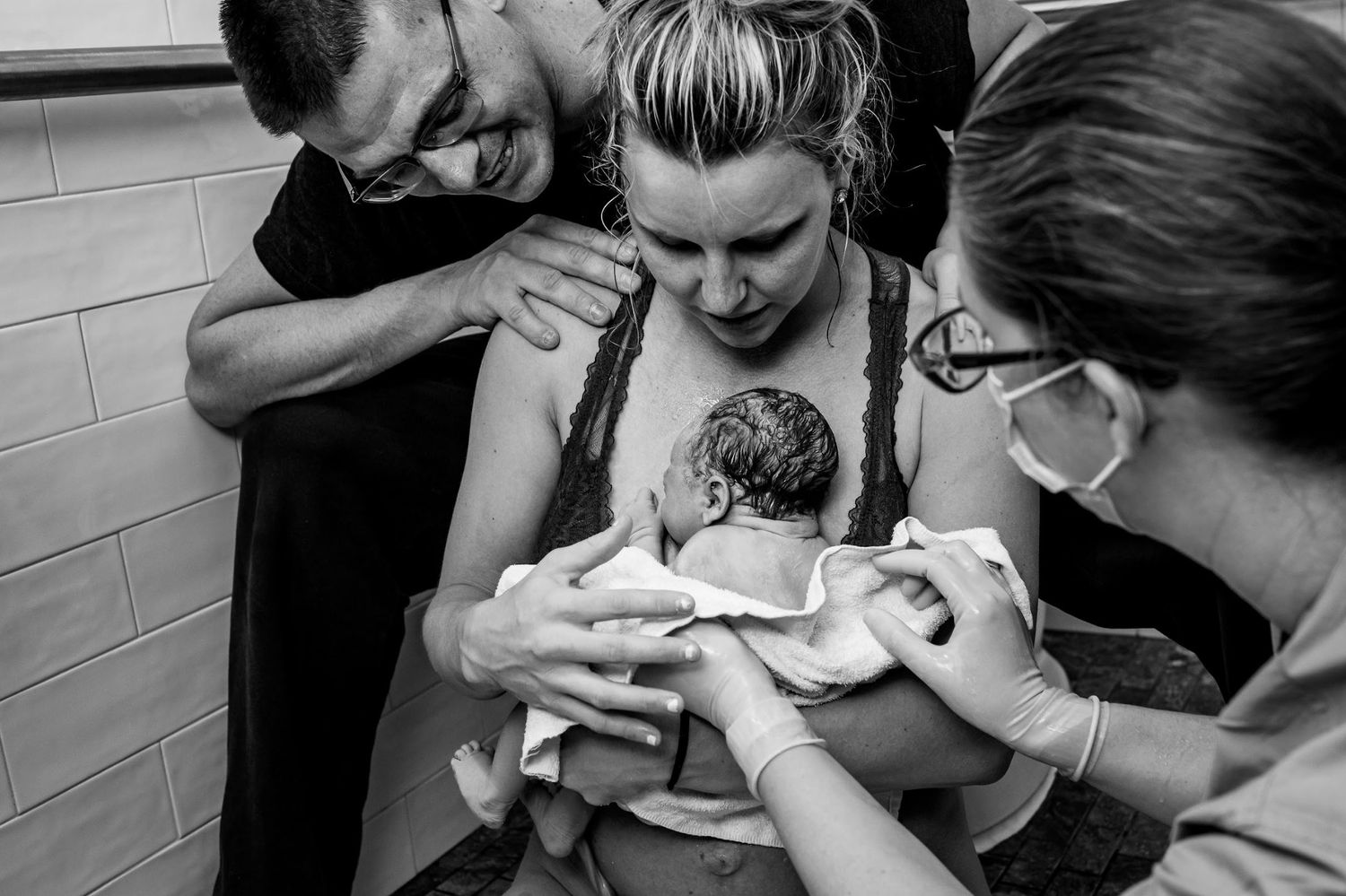 Medical professionals assist with newborn care immediately after birth.