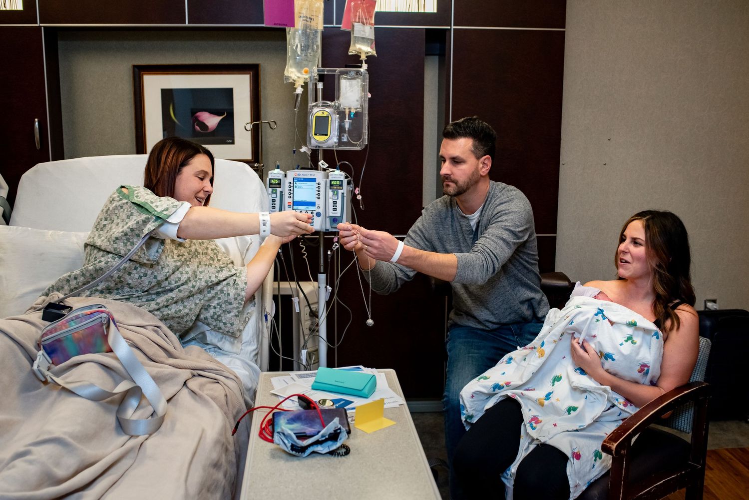 Hospital patients sharing moment after the birth of a surrogate baby