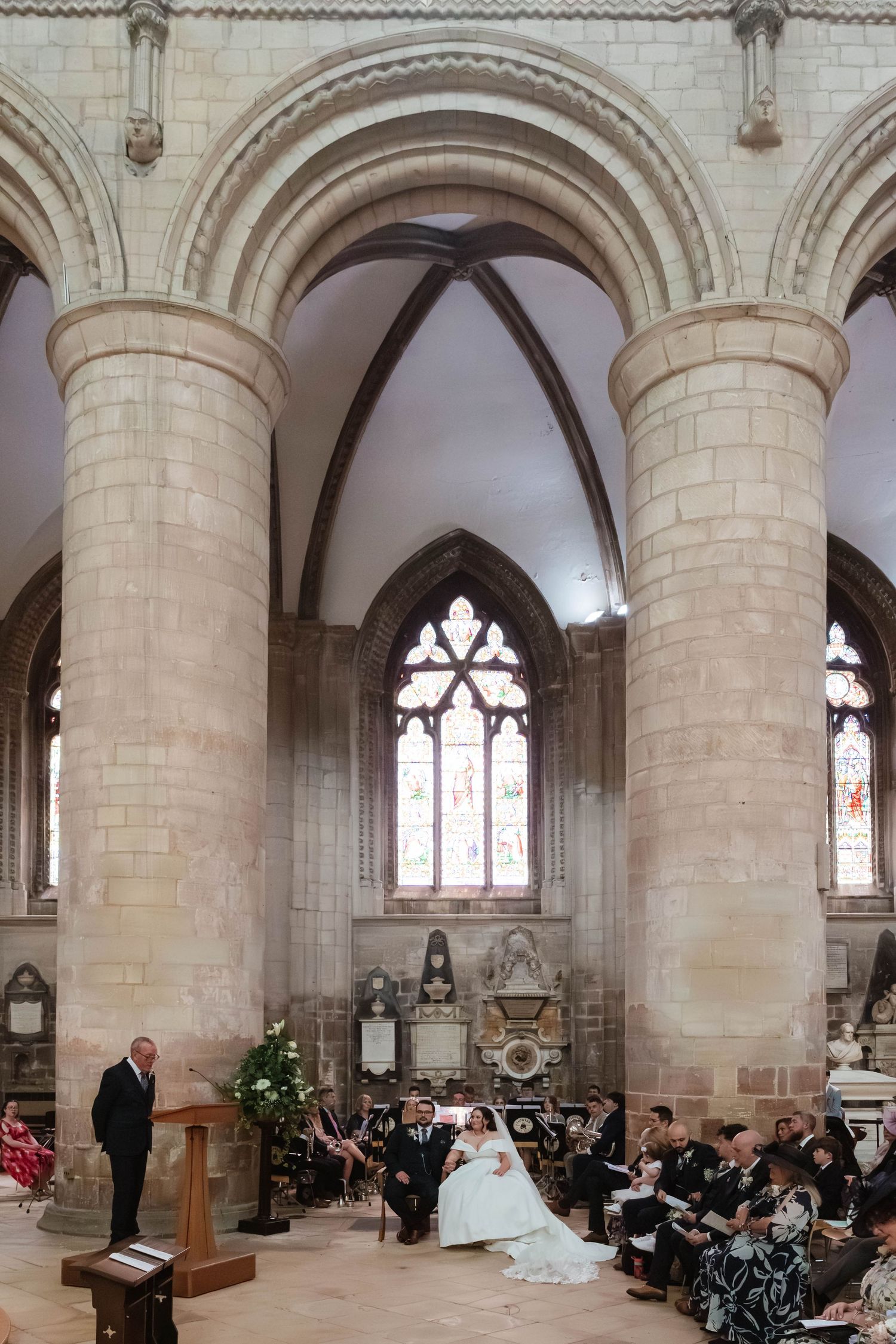 Gloucester Cathedral wedding photographer Gloucestershire Cheltenham Cotswolds Bride and Groom in the nave during a reading