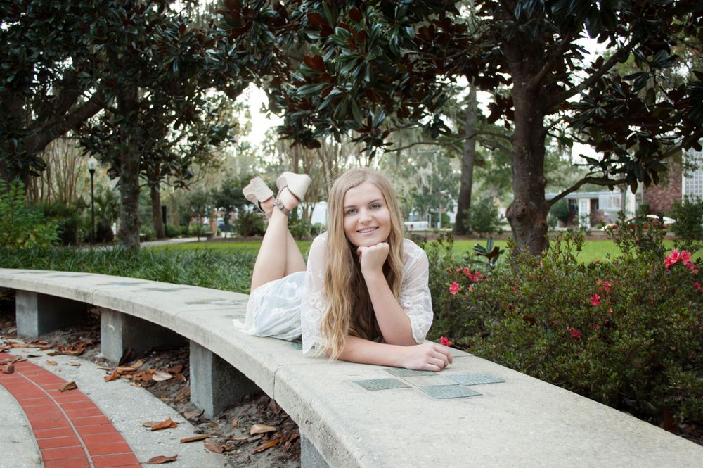 Solo female senior high school grad session excitement. Soft afternoon natural lighting in Gainesville Florida at the Thomas Center
