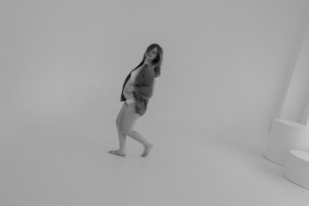 Lifestyle maternity photographer capturing candid moment at Gallery 48 in Rochester, NY.