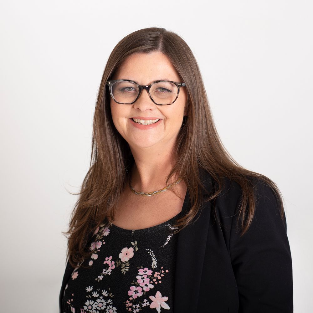 Smart woman in glasses smiles for headshot
