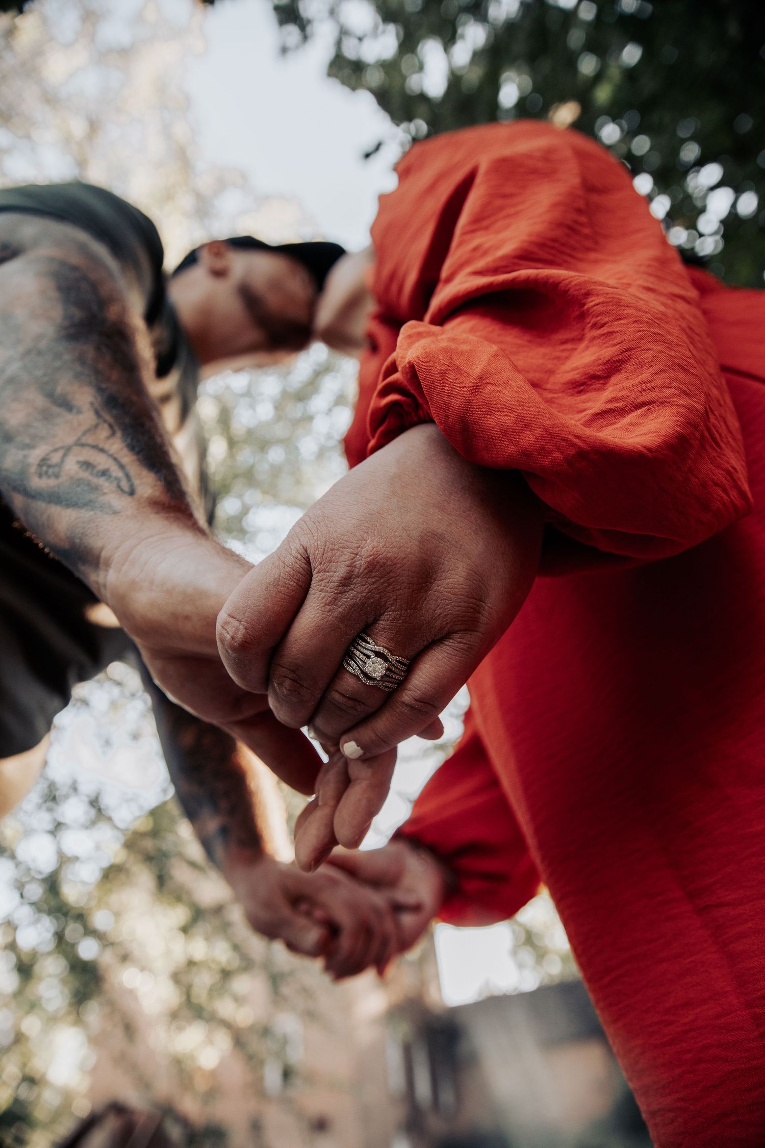 Close-up shots of hands holding each other against a blurred natural background.