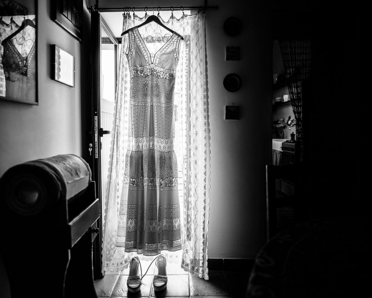 Dramatic black and white interior shots showing sunlight through lace curtains.