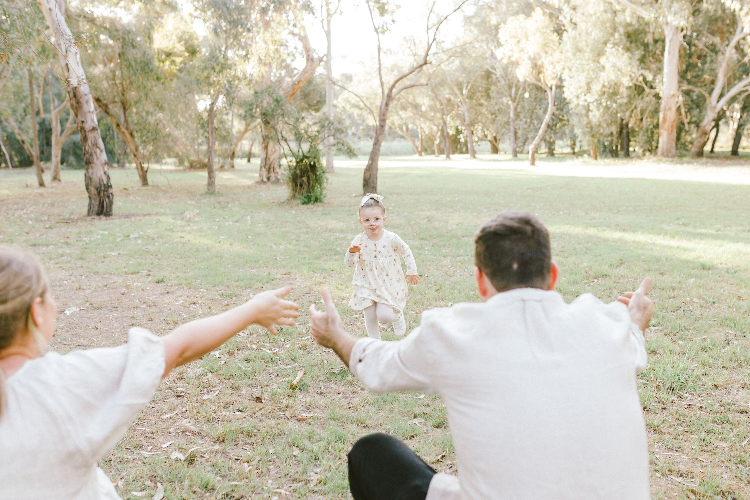 Someone throws colorful flower petals in an outdoor setting during autumn creating a magical moment in the park.