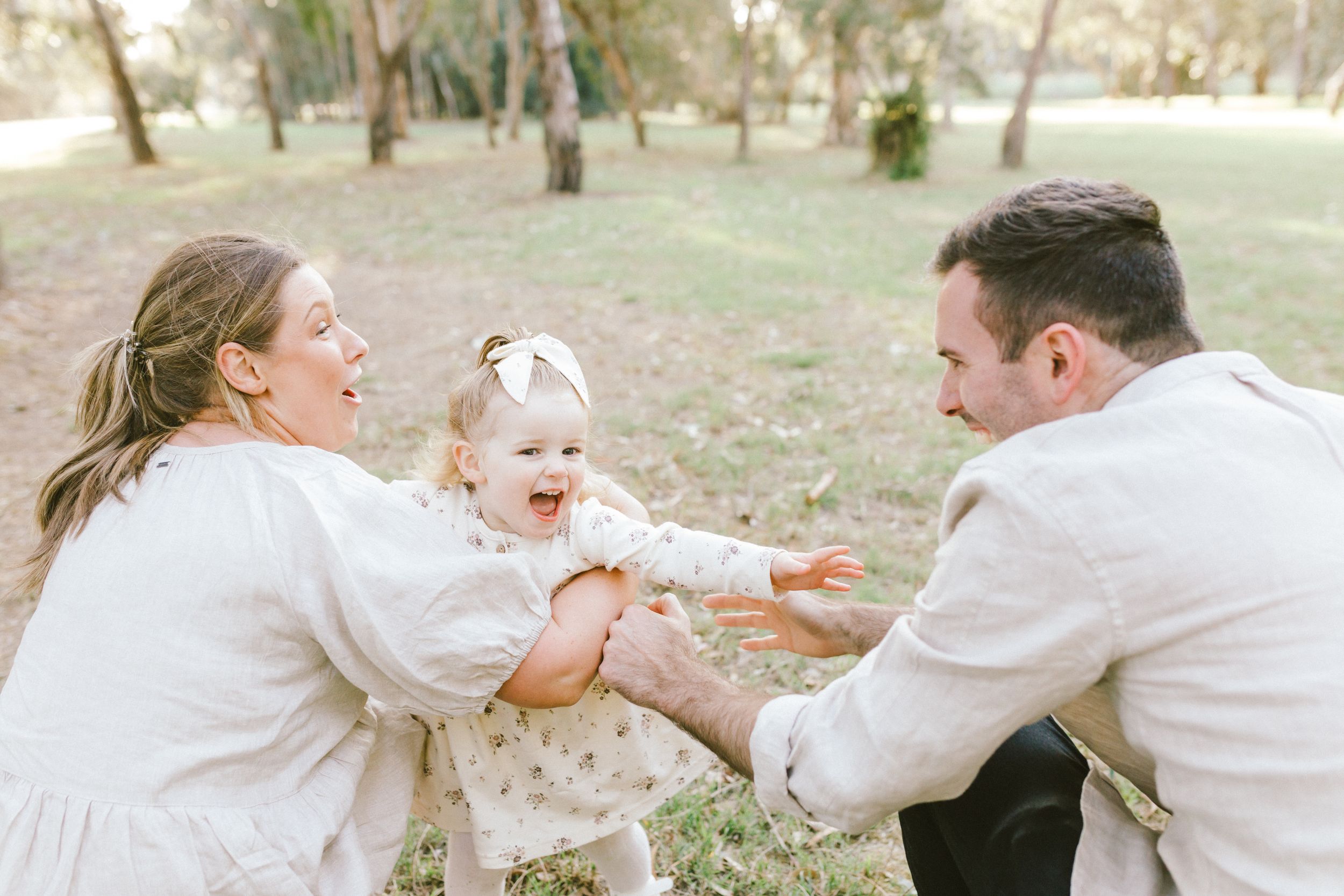 Four photos show a loving family sharing joyful moments together in a sun-drenched outdoor setting.