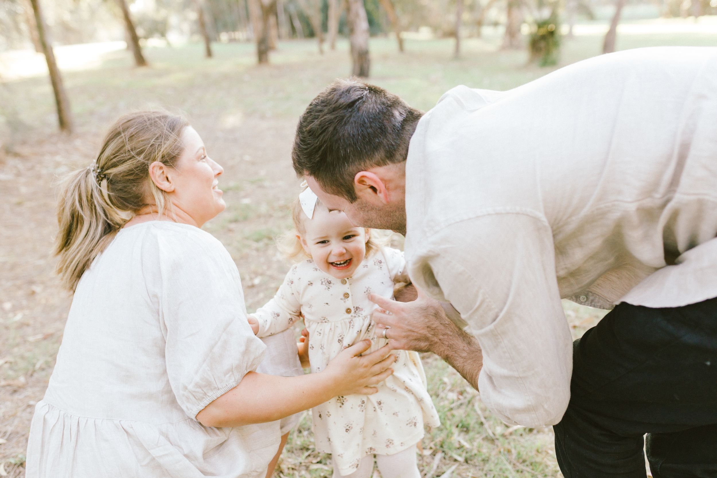A romantic series of candid moments between a couple during an outdoor wedding photoshoot in a rustic setting.
