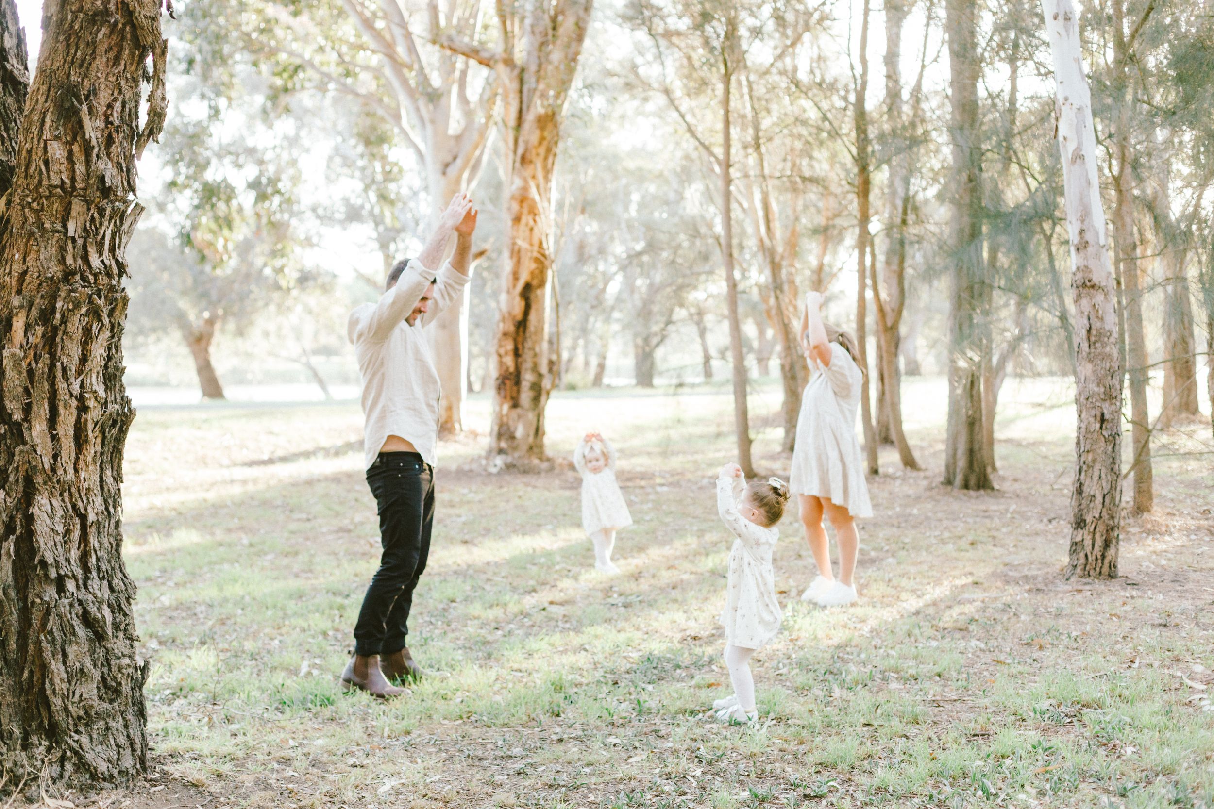 A series of romantic couple photos taken among tall eucalyptus trees in a dreamy outdoor setting.