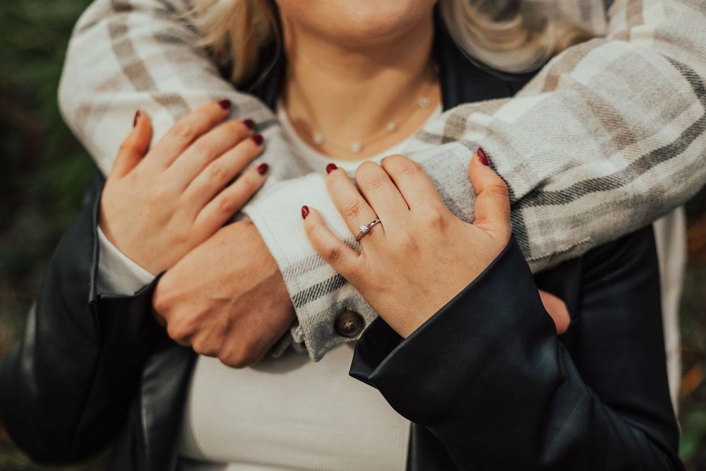 Close up photos of hands showing off engagement rings with varying poses and angles, highlighting sparkling diamond rings.