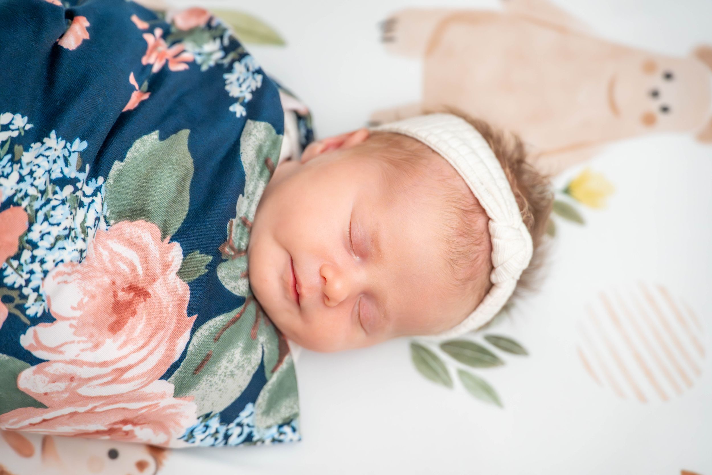Newborn photography collage with delicate floral elements and navy blue accents. Quad Cities Newborn Photography