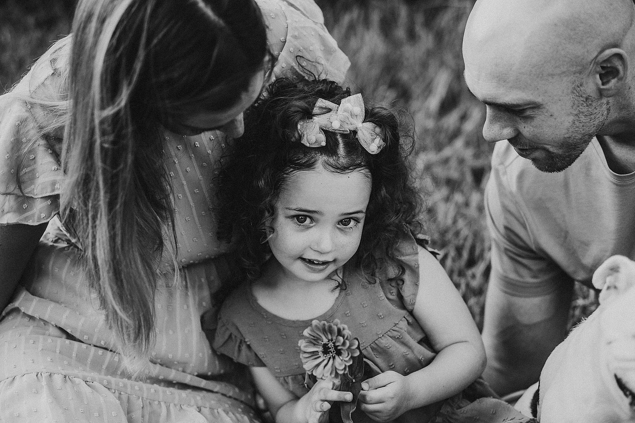 Group of smiling kids exploring and playing together outdoors in black and white photography.